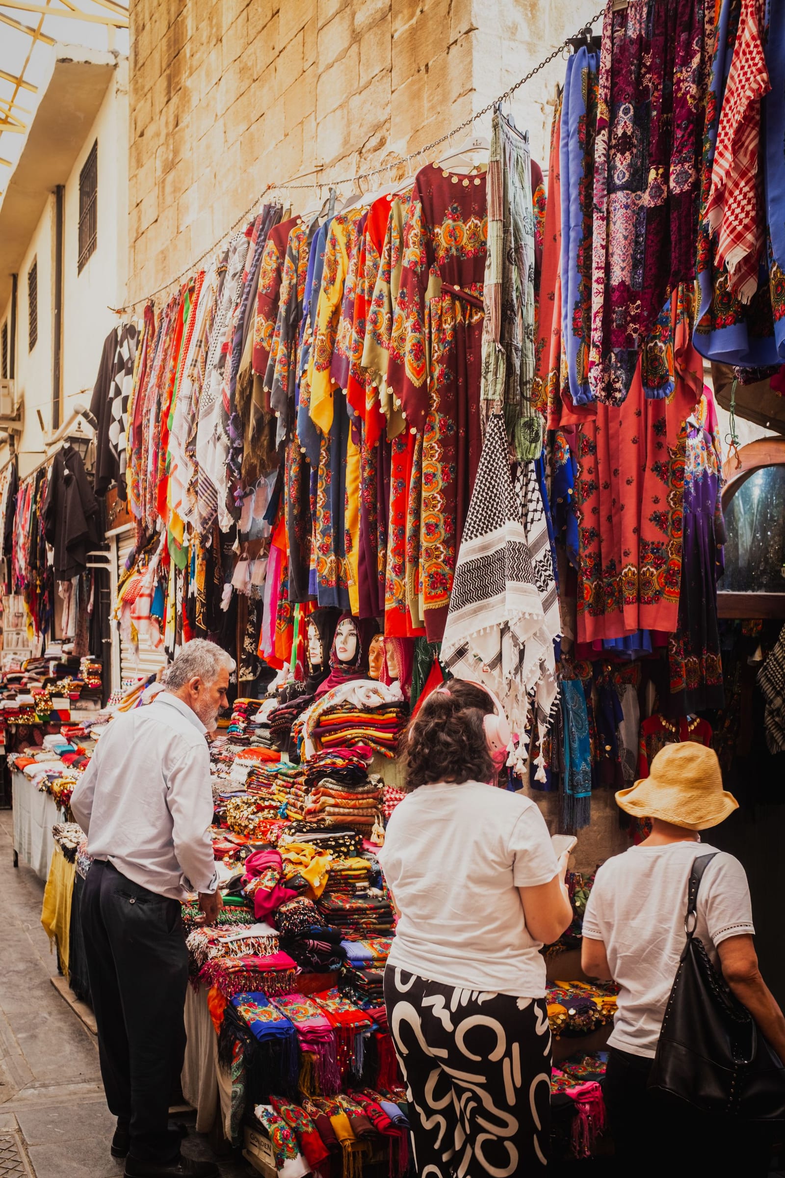 Market stall with colorful textiles and handicrafts