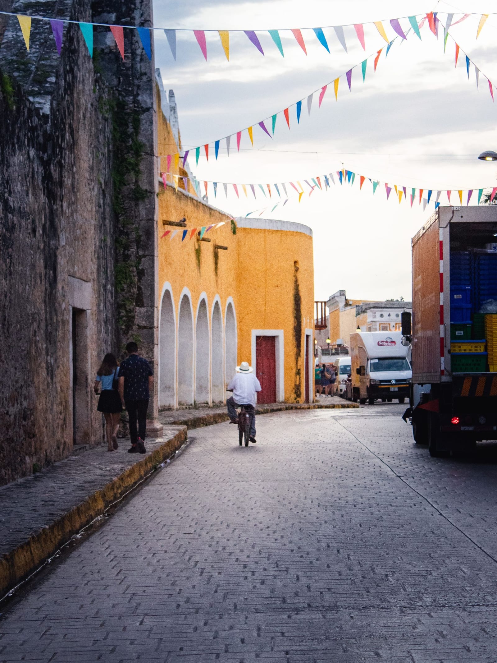 Colorful colonial street draped with papel picado in Valladolid, Yucatán